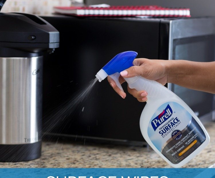 PURELL surface disinfecting wipes canister on an office desk